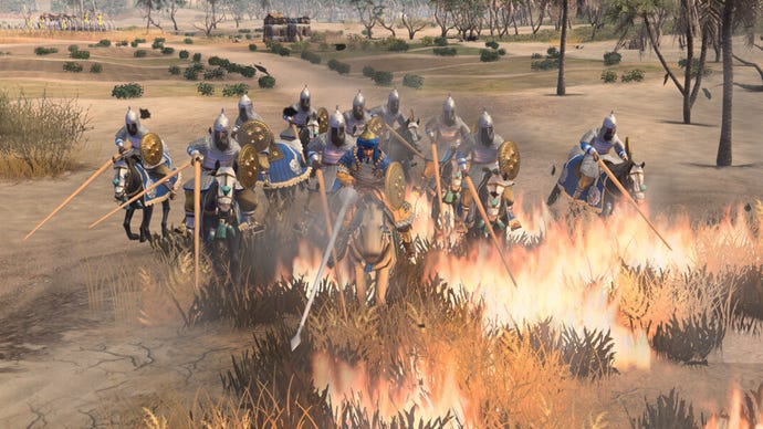 Knights charge over burning grass in Age of Empires 4 DLC The Sultans Ascend